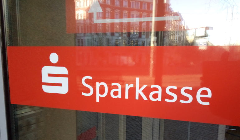 Sparkassen-Logo auf einer Automatiktür am Eingang der Sparkassenfiliale am Hasselbachplatz.