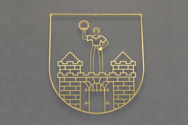 Magdeburger Stadtwappen in Gold vor einem grauen Hintergrund.
